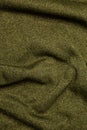 Texture of knitted fabric in green color. Light khaki back