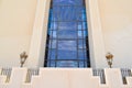 texture of a large huge glass blue window and a beige stone wall in the Egyptian Orthodox Christian church. The background.