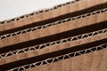 Texture of layered brown cardboard side. Folded cardboard boxes