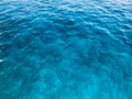 Texture light blue wet beautiful azure glowing transparent sea, ocean water, sea, ocean with small waves, light ripples. The backg