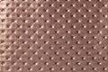 Texture of light brown leather background with capitone pattern, macro