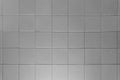The texture of light gray square glossy ceramic tiles with water drops. Soft lighting