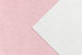 Texture of light pink paper background, half two colors with white arrow, macro. Structure of craft rose cardboard Royalty Free Stock Photo