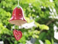 Ceramic bell painted red color. Hanging decorated with red heart symbol. Royalty Free Stock Photo