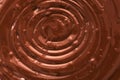 The texture of liquid chocolate whirl. Beautiful background of melted chocolate