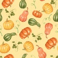 Texture made of pumpkin vegetable and green leaves on a uniform yellow background. Royalty Free Stock Photo