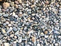 Texture of many multicolored beautiful round and oval smooth natural stones, pebbles. The background Royalty Free Stock Photo