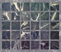 The texture of marble with square elements of blue, cold shades. Blue, purple and granite squares on a marble background