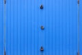 Texture of a metal blue wall with a gate closed for three locks Royalty Free Stock Photo