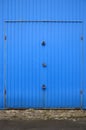 Texture of a metal blue wall with a gate closed for three locks Royalty Free Stock Photo