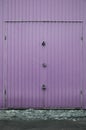 Texture of a metal violet wall with a gate closed for three lock Royalty Free Stock Photo