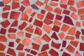 The texture of mosaic wall decorative ornament from ceramic broken tile in orange color, like Gaudi