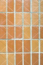 The texture of mosaic wall decorative ornament from ceramic tile in orange color. Royalty Free Stock Photo