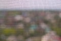 The texture of the mosquito net on the window. Insect protection. The grid is in focus, the landscape outside the window is Royalty Free Stock Photo