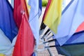 Texture of multi-colored festive red, blue, yellow flags made of fabric. The background. Royalty Free Stock Photo