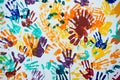 Multi-colored prints of hands smeared with paint on a white wall Royalty Free Stock Photo