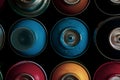 Texture of multi-colored spray cans with paint for graffiti