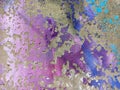 Texture of a multi-colored stone wall. Cracked paint on a concrete wall. Peeling paint. Painted wall with abstract patterns of