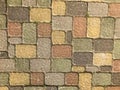 Texture of multicolored beautiful rectangular stone concrete paving brick tiles with seams overgrown with green grass. background Royalty Free Stock Photo