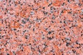 Texture of natural granite, red, scarlet black speckle. Royalty Free Stock Photo