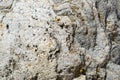 Texture of natural carved solid strong rough textured mineral gray brown stone cobblestone walls of the rock. Stone background Royalty Free Stock Photo