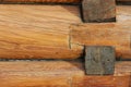 Texture of natural wood close up. New log house. Yellow lacquered wood. Old technology. Royalty Free Stock Photo