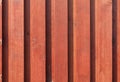 New brown-red wooden fence in the rays of sunlight Royalty Free Stock Photo