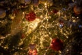 texture new year. Close-up of a Christmas tree branch with decorative balls, toys and a shining garland. soft focus Royalty Free Stock Photo