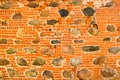 The texture of the old ancient medieval antique stone hard peeling cracked brick wall of rectangular red clay bricks and large Royalty Free Stock Photo