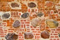 The texture of the old ancient medieval antique stone hard peeling cracked brick wall of rectangular red clay bricks and large Royalty Free Stock Photo