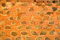 The texture of the old ancient medieval antique stone hard peeling cracked brick wall of rectangular red clay bricks and large Royalty Free Stock Photo