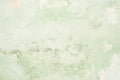 The texture of the old antique wall is green, there are fractures of the white protective layer of plaster from the effects Royalty Free Stock Photo