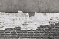 Texture of an old black brick wall with destroyed plaster Royalty Free Stock Photo