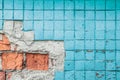 Texture of old blue tile wall. Background of Wall fragment with broken tile and bricks Royalty Free Stock Photo