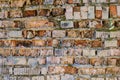 The texture of an old brick wall, cracked by time and weather. Moss-grown brick walls Royalty Free Stock Photo