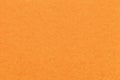 Texture of old bright orange paper background, closeup. Structure of dense carrot cardboard Royalty Free Stock Photo