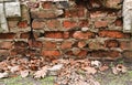 a crumbling red brick wall. broken bricks Royalty Free Stock Photo