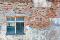 Texture of an old building with a window. Background ruined plaster and old brickwork Royalty Free Stock Photo