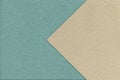 Texture of old craft blue paper background, half two colors with light beige arrow. Vintage kraft sand cardboard