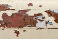 Heavily cracked and peeled metal sheet once covered with red and beige paint as an abstract industrial background Royalty Free Stock Photo