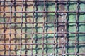 Texture from an old gray iron grate on a green metal wall Royalty Free Stock Photo