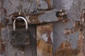 Texture of old gray painted wooden door with peeled paint and of old rusty padlock Royalty Free Stock Photo