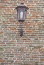 Texture of old hanging lantern on fortress brick wall pattern