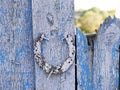 Texture of old iron horseshoe and wooden surface of the gate, in the village Royalty Free Stock Photo