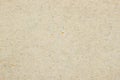 Texture of old organic light cream paper. Recyclable material with small brown and and blue inclusions of cellulose Royalty Free Stock Photo