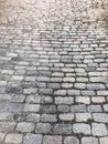The texture of the old pedestrian stone-paved stone brick gray road with seams. The background Royalty Free Stock Photo