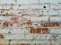 Texture of an old red brick wall partially painted white in cloudy weather Royalty Free Stock Photo