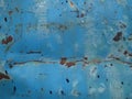 The texture of an old and rusted blue steel plate is used as a design background Royalty Free Stock Photo