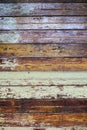 Texture, old rustic paint-striped wood slatted wall covered with peeling paint