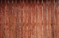 The texture of an old rustic wooden fence made of flat processed boards. Detailed image of a street fence of a rustic type made o Royalty Free Stock Photo